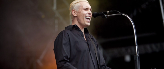 Man standing microphone black shirt free wallpaper - medium preview image