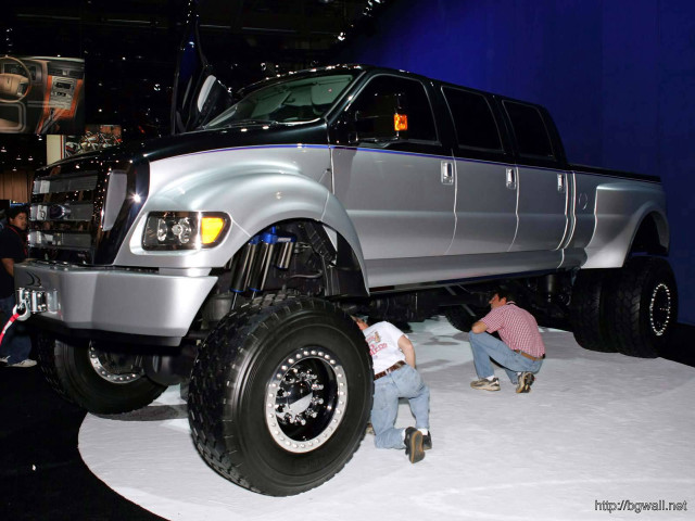Couple fixing large truck showroom free wallpaper - medium preview image