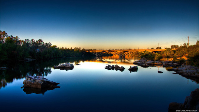 Bridge river rocks trees sunset free wallpaper - medium preview image