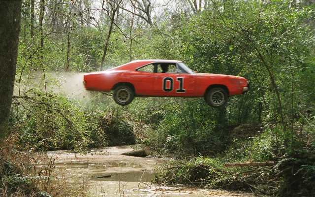 Red car jumping muddy stream free wallpaper - medium preview image