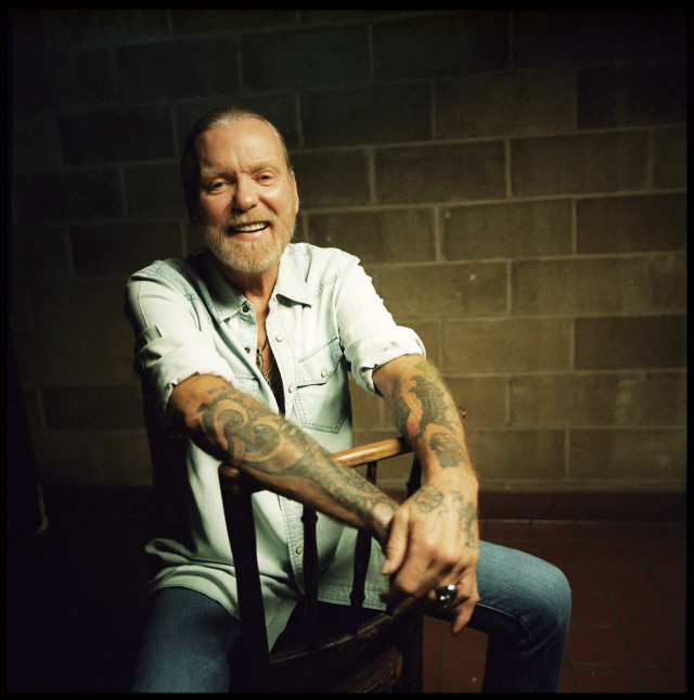 Man tattoo chair smiling camera free wallpaper - medium preview image