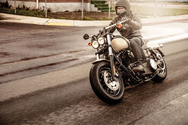 Man motorcycle street sign building free wallpaper - medium preview image