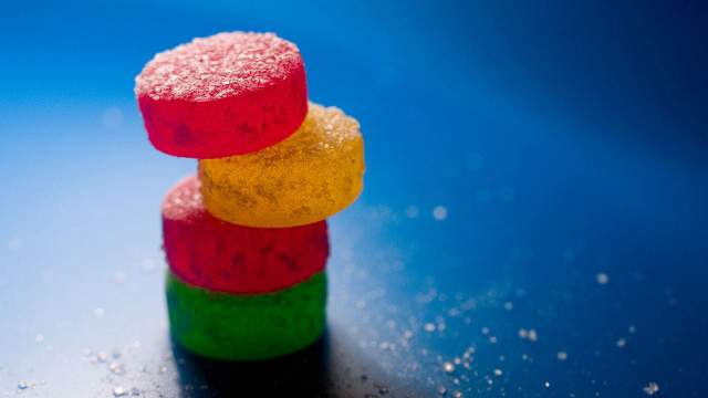 Colorful candies stack blue surface free wallpaper - medium preview image