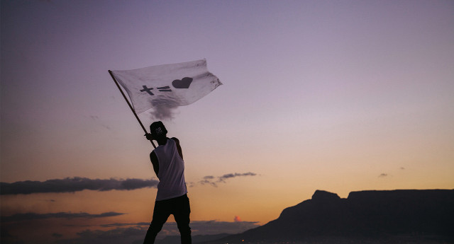 Man holding flag beach sunset free wallpaper - medium preview image