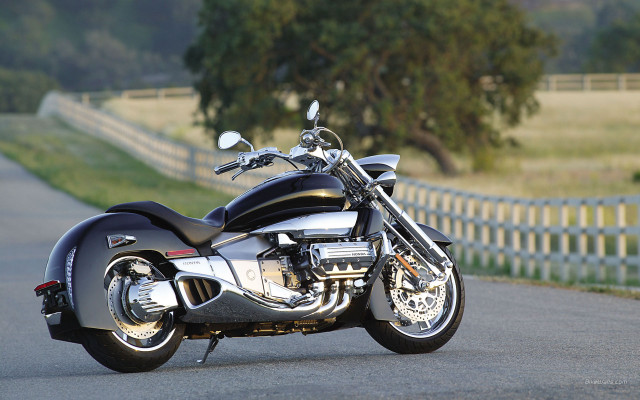 Motorcycle parked road fence grass free wallpaper - medium preview image