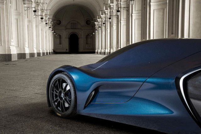 Blue car parked building columns free wallpaper - medium preview image