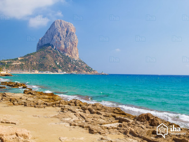 Rocky beach mountain blue water free wallpaper - medium preview image