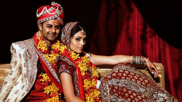 Couple indian attire couch red free wallpaper - medium preview image