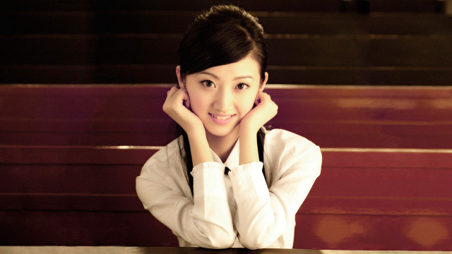Woman smiling at table hands free wallpaper - medium preview image