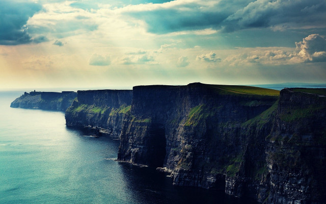 Cliff face water cloudy sky free wallpaper - medium preview image