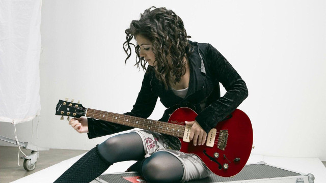 Woman sitting floor red guitar free wallpaper - medium preview image