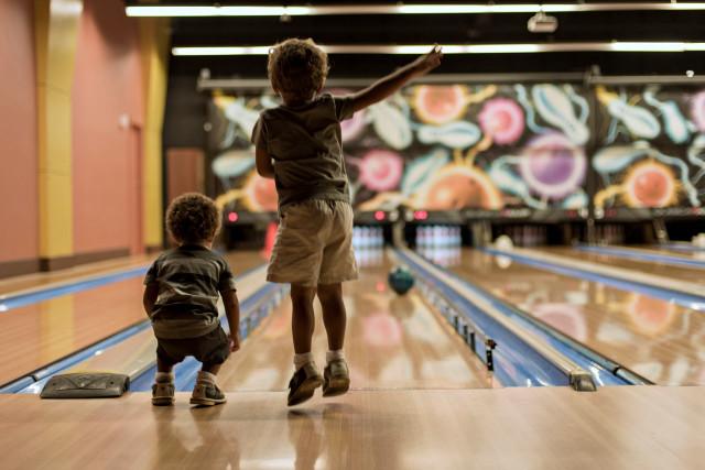 Boy bowling alley shallow depth free wallpaper - medium preview image