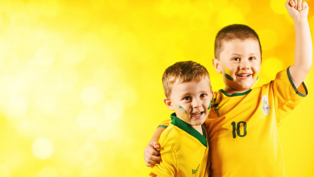 Two boys soccer ball yellow free wallpaper - medium preview image