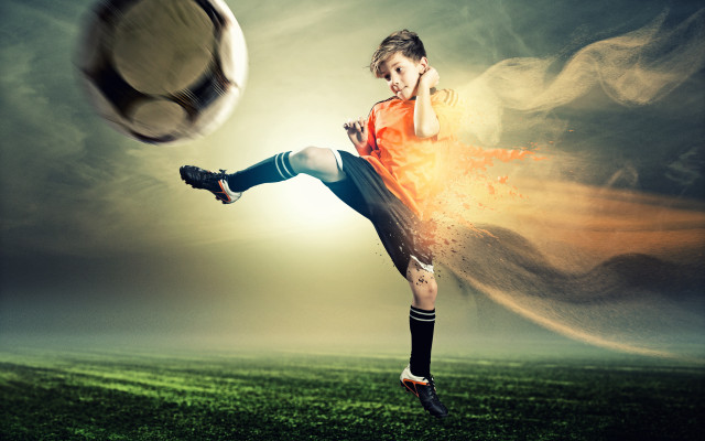 Young boy kicking soccer ball free wallpaper - medium preview image
