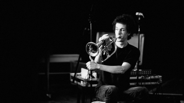 Man sitting chair holding trumpet free wallpaper - medium preview image