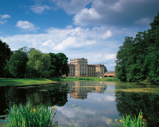 Large building lush green field free wallpaper - medium preview image