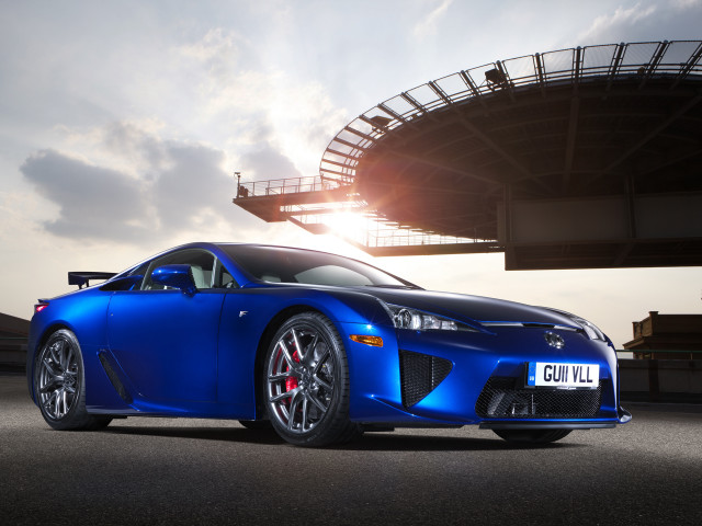 Blue sports car stadium sunflare free wallpaper - medium preview image