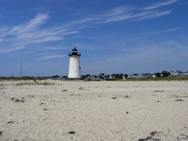 Lighthouse sandy beach blue sky free wallpaper - medium preview image