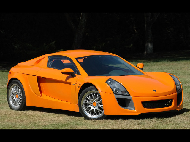 Bright orange sports car grass free wallpaper - medium preview image