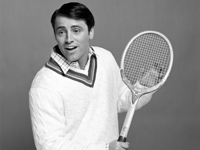 Man holding tennis racket smiling free wallpaper - medium preview image