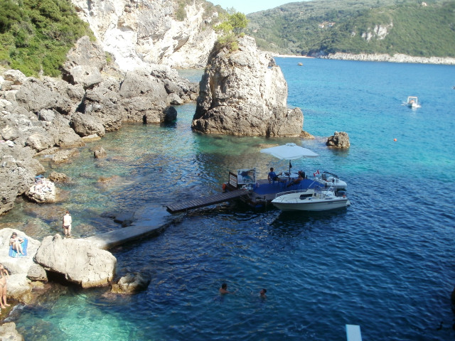 Boat docked rocky shore people free wallpaper - medium preview image