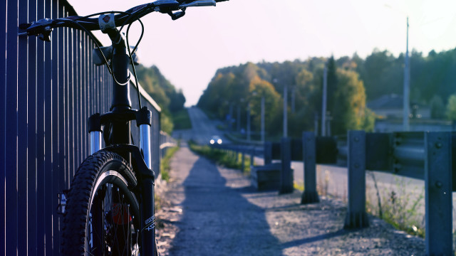 Bike parked fence roadside trees free wallpaper - medium preview image