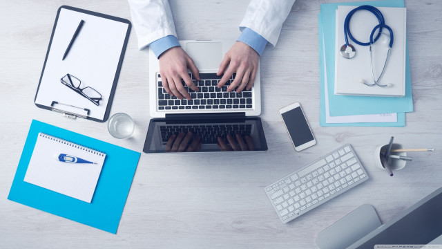 Person typing laptop medical office free wallpaper - medium preview image