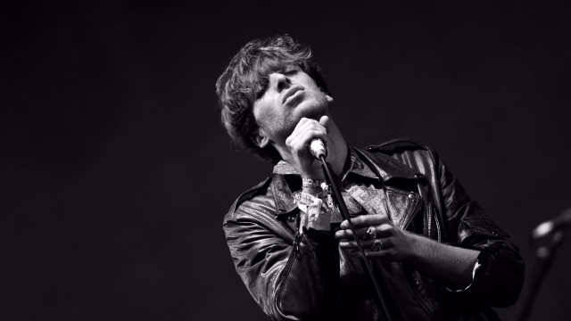 Man holding microphone stage speaking free wallpaper - medium preview image