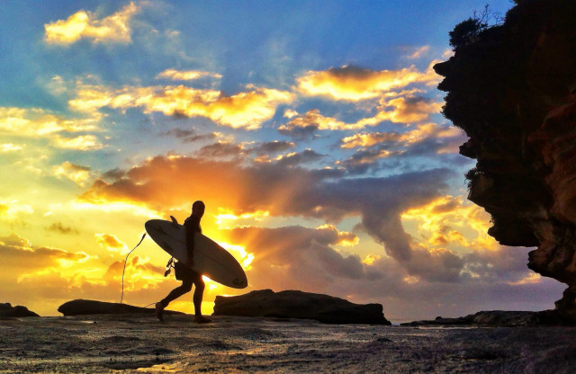 Person walking beach surfboard cloudy free wallpaper - medium preview image