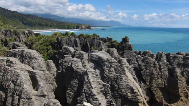 Beach rocky cliff water sky free wallpaper - medium preview image