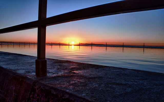 Sunset fence water background serene free wallpaper - medium preview image