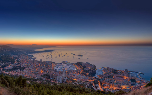 City lit night ocean mountains free wallpaper - medium preview image