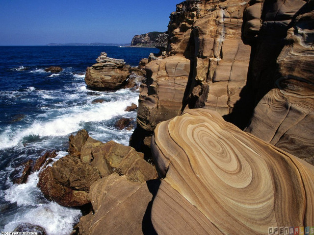 Rocky cliff waves ocean boat free wallpaper - medium preview image