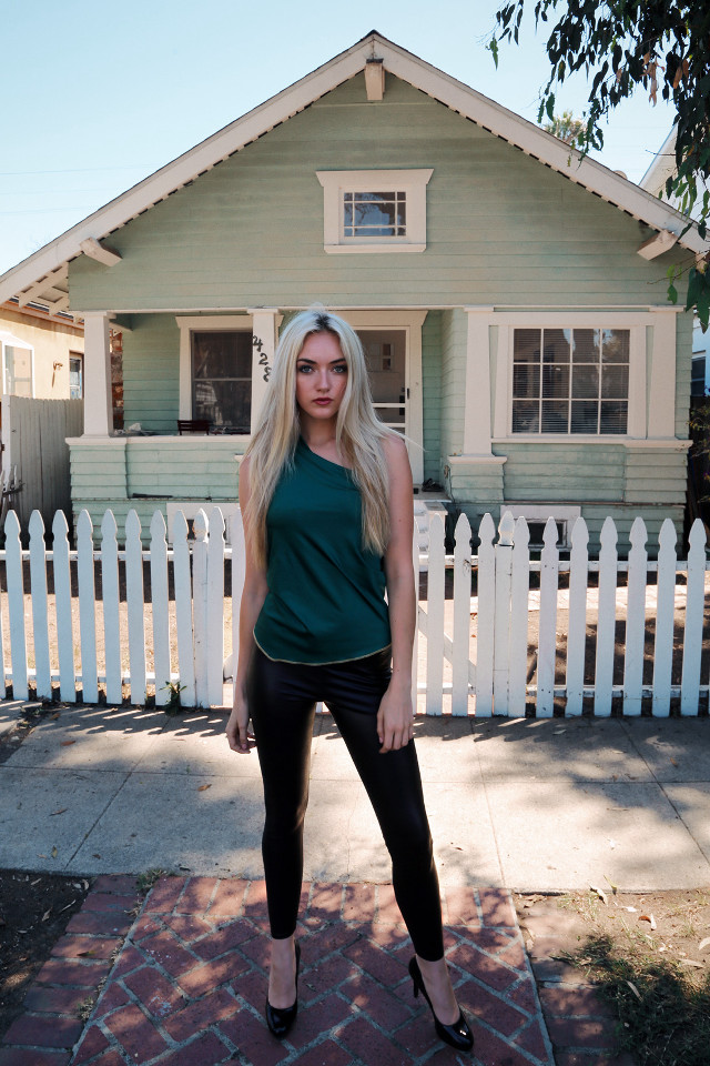Woman standing house white picket free wallpaper - medium preview image