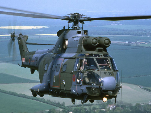 Helicopter flying lush green countryside free wallpaper - medium preview image