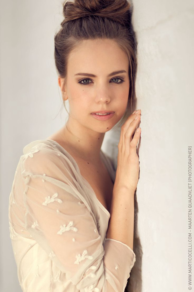 Woman bun hair leaning wall free wallpaper - medium preview image