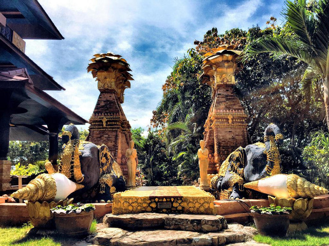 Statues lush green field building free wallpaper - medium preview image