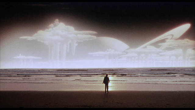 Man beach ocean cloudy sky free wallpaper - medium preview image