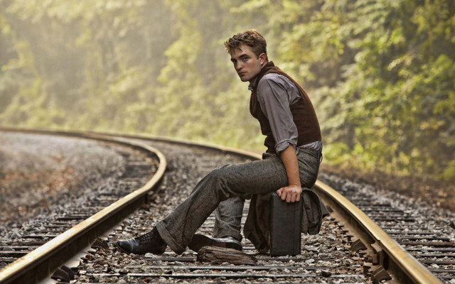 Man sitting train track suitcase free wallpaper - medium preview image