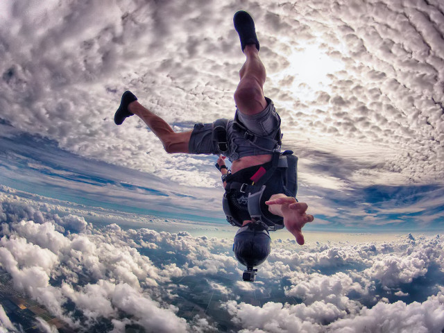 Man skydiving clouds feet up free wallpaper - medium preview image