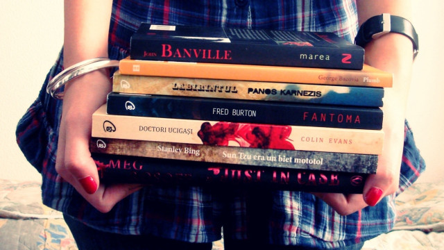 Woman holding stack of books free wallpaper - medium preview image