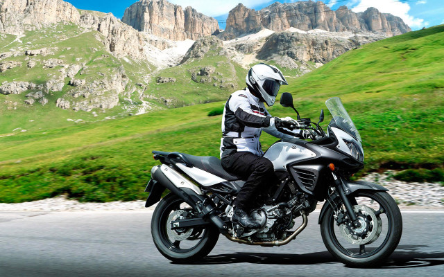 Man motorcycle road green hillside free wallpaper - medium preview image