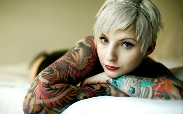 Woman tattoos bed arms crossed free wallpaper - medium preview image