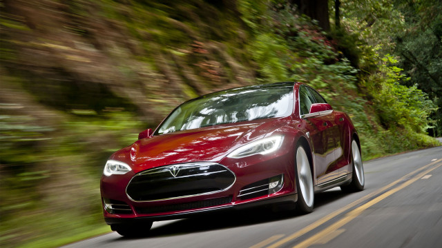 Red tesla car driving woods free wallpaper - medium preview image