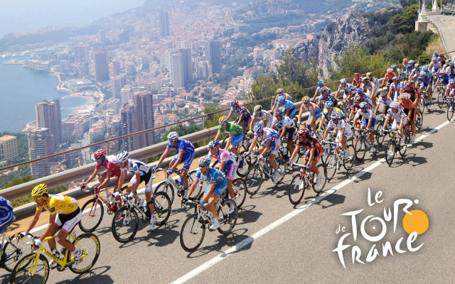 Cyclists city skyline road buildings free wallpaper for desktop - medium preview image