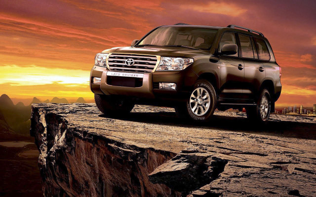 Brown suv rocky cliff sunset free wallpaper - medium preview image