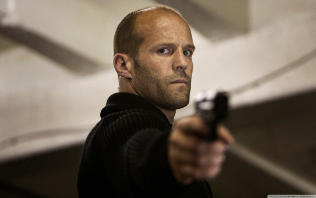 Man holding gun serious look #2 free wallpaper - medium preview image