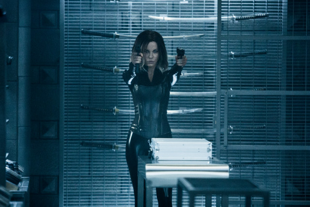 Woman black leather gun room free wallpaper - medium preview image