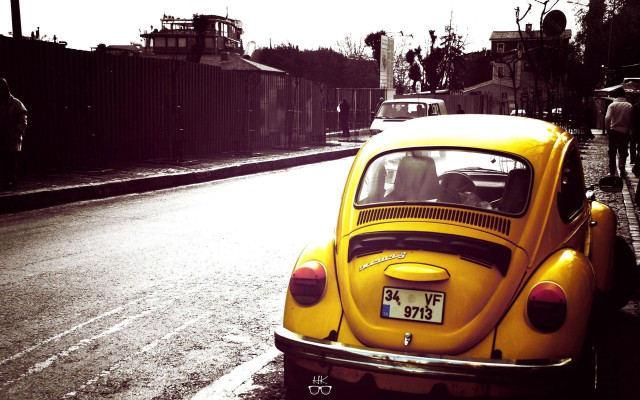 Yellow car parked road fence free wallpaper - medium preview image