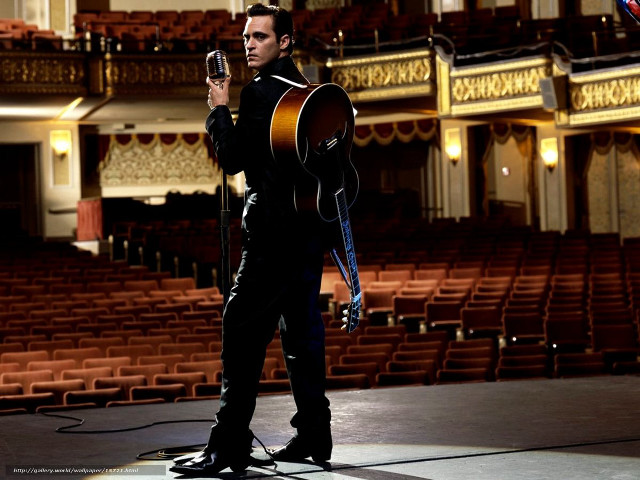 Man holding guitar auditorium microphone free wallpaper - medium preview image
